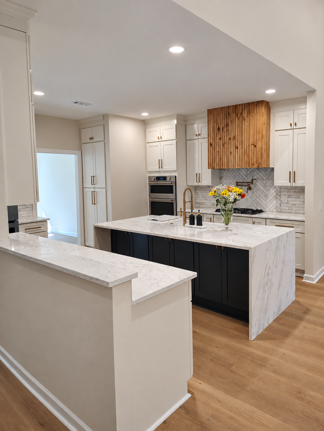 Finished modern kitchen with white cabinetry and dark island