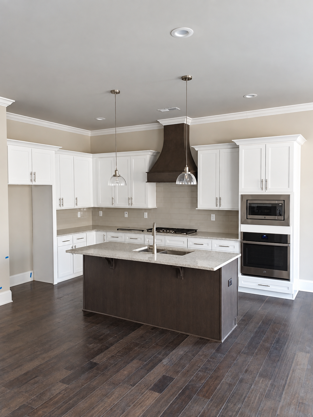 Finished white kitchen with contrasting dark island